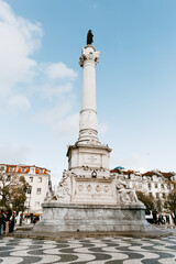 Praca do Rossio plaza square in Lisbon Portugal that is famous for its black and white rolling...