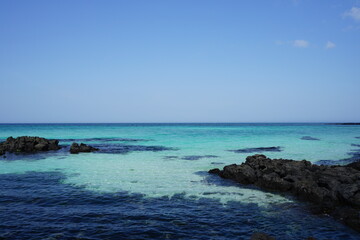 Fototapeta premium rock beach and clear bluish sea