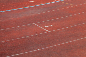 the red surface of the old running track at the stadium