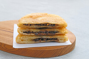 Hotteok, South Korean pancakes or fried dough with nuts and sugar filling, traditional street food. Selected focus.
