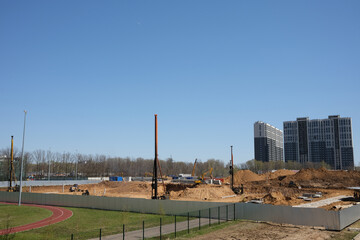Driving and forming the pile foundation. Pile driven into ground by vibrating hydraulic hammer.