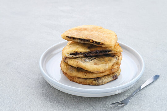 Hotteok, South Korean pancakes or fried dough with nuts and sugar filling, traditional street food. Selected focus.
