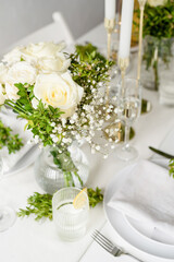 The wedding decor. Wedding teble decoration with white roses