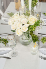 The wedding decor. Wedding teble decoration with white roses, closeup