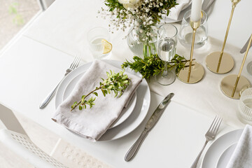 The wedding table setting, high angle view . Wedding teble decoration with white roses and boxwood