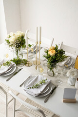 The wedding table setting, high angle view . Wedding teble decoration with white roses and boxwood