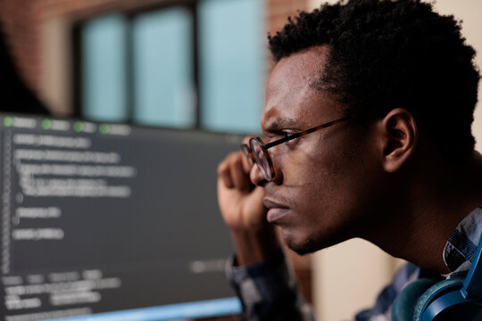 Computer programmer puzzled by nonfunctional security algorithm and company corrupted database. Confused tech engineer sitting doubtful at computer trying to solve network processing errors.