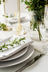The wedding table setting, high angle view . Wedding table decoration with white roses and boxwood
