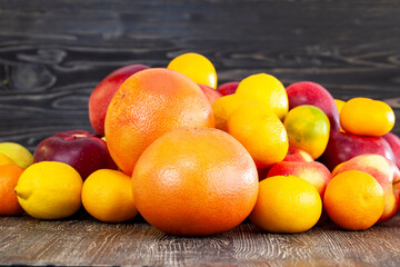 a bunch of citrus tangerines and other fruits together