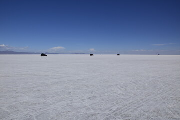 Salar de Uyuni, Bolivia. Off-road cars driving through the salt flat Salar de Uyuni in Bolivia