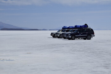 Uyuni, Bolivia - 09 february 2017: Salar de Uyuni, Bolivia. Off-road cars on the salt flat Salar de Uyuni in Bolivia