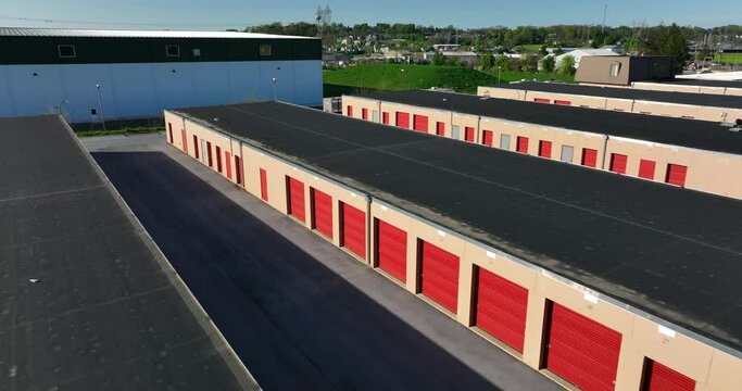 Self storage rental building. Red orange door. Aerial view.
