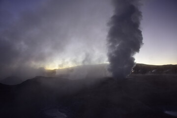 A geyser shoots out of the ground, a photo at dawn on a long exposure., on Eduardo Avaroa National Reserve in Uyuni