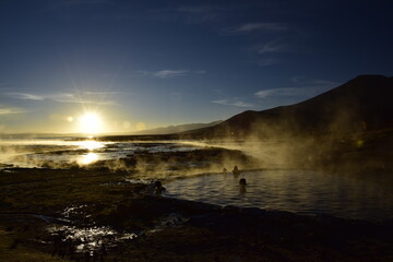 Tourists swim in a hot spring at sunrise in Eduardo Avaroa National Reserve in Uyuni, Bolivia.