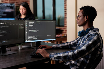 Cyber security company employee developing blockchain based database processing system. Cybernetic officer coding a machine learning software to protect mainframe encrypted files.