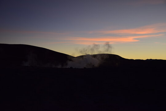 A geyser shoots out of the ground, a photo at dawn on a long exposure., on Eduardo Avaroa National Reserve in Uyuni