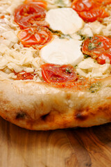 Premium high quality pizza with mozzarella cheese and tomato. Italian style dish with top products. Close up.