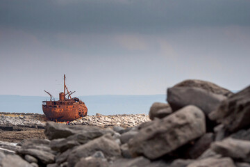 Plassey shipwreck on shore of Inisheer island. Aran islands, county Galway, Ireland. Rough stone coast with abandoned old rusty cargo ship. Popular tourist landmark and attraction. Irish landscape
