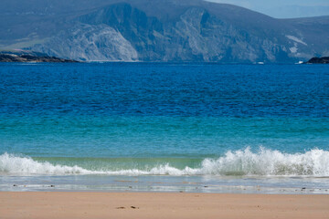 Beautiful sandy Keem beach in Achill island, county Mayo, Ireland. Warm sunny day. Popular travel area with amazing view and nature.