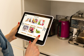 Woman using digital tablet to shop online
