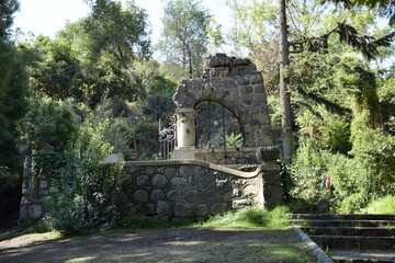Fototapeta na wymiar Stone arch with metal web in the city park. Santiago, Chile