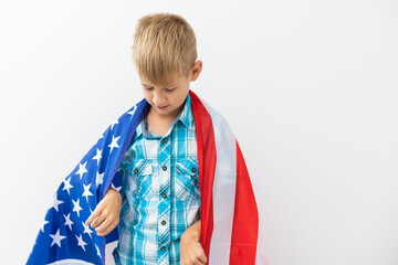 Boy holding American flag, isolated on white