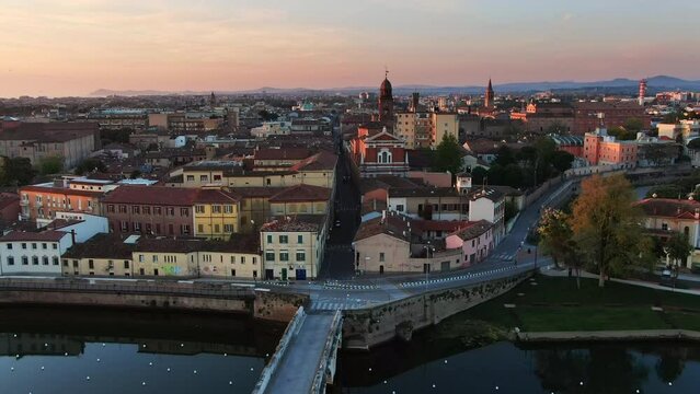 rimini city old town center skyline aerial view drone at sunrise,flying over ponte tiberio and santa maria in corte church 4k