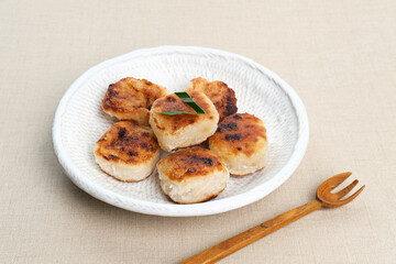 Wingko or Wingko Babat, a traditional Indonesian snack made from grated young coconut, glutinous rice flour, and sugar. Selected focus.
