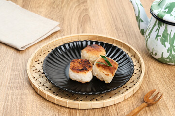 Wingko or Wingko Babat, a traditional Indonesian snack made from grated young coconut, glutinous rice flour, and sugar. Selected focus.
