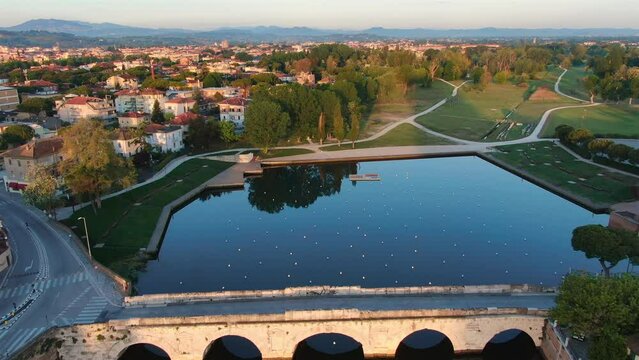 rimini city famous landmark tiberius bridge aerial view drone,historic attraction ponte tiberio and xxv aprile park at sunrise 4k