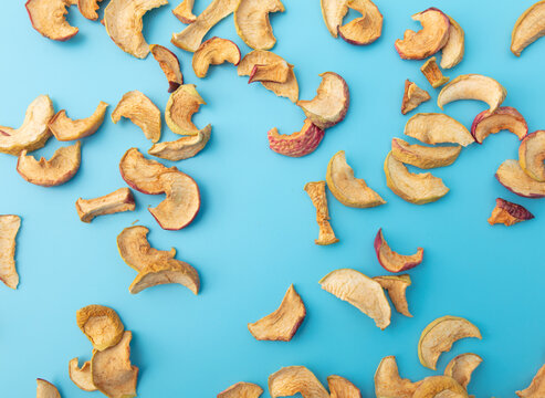 Dried apples on a blue background.