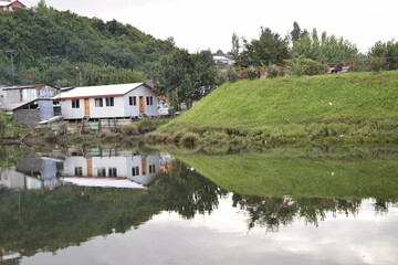 Fototapeta na wymiar Houses on stilts (palafitos) reflected in the water in Castro, Chiloe Island, Patagonia, Chile