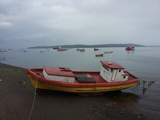 Fototapeta premium QUELLON, CHILE. Colourful fishing boats in the coastal town of Quellon on the island of Chiloe in Chile