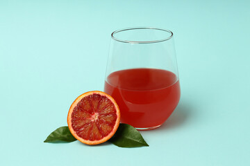 Concept of drink, red orange juice on blue background