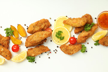 Concept of tasty food with chicken strips on white background