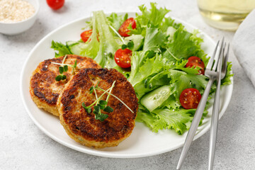 Vegan food plate. Quinoa burgers cutlets served with lettuce, tomatoes, microgreens. Diet concept, close up