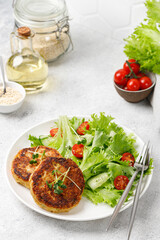 Quinoa cutlets served with lettuce, tomatoes, microgreens. Diet concept, Vegan food plate.