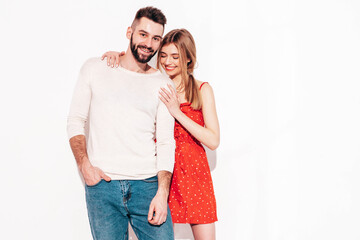 Sexy smiling beautiful woman and her handsome boyfriend. Happy cheerful family having tender moments near blue wall in studio.Pure cheerful models hugging.Embracing each other. Cheerful and happy