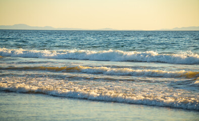 Waves in the ocean. Turquoise sea waves. Beautiful sea waves with foam of blue and turquoise color.