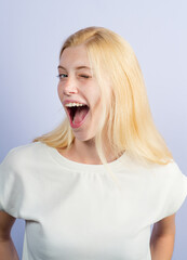 Woman isolated on white background winking. Funny young girl winks gesture. Emotions on face.