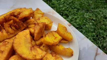 Details of fried cassava on a white plate, a snack from Indonesia made from cassava