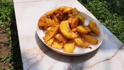 Fried cassava on a white plate, a snack from Indonesia made from cassava