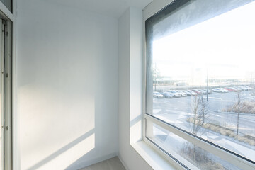 Glazed balcony in the new building, view of the entrance to the balcony