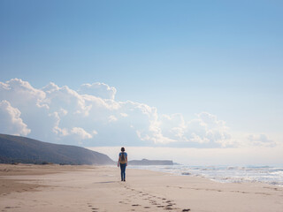 Backpacker female sitting on the Patara sand dunes beach enjoying the windy Mediterranean Sea during Lycian Way trekking walk. Famous Likya Yolu Turkish route. Active people vacation concept image