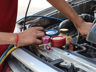 Technician check car air conditioning system refrigerant recharge