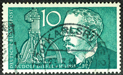 GERMANY - CIRCA 1958: a postage stamp printed in Germany showing a Portrait of engineer Rudolf Diesel with part of a photo in the background. For the 100th birthday. Circa 1958.
