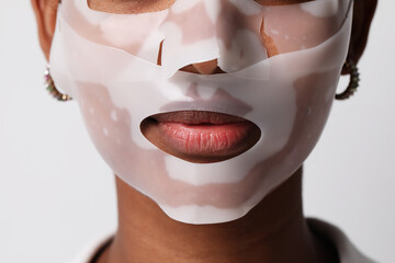 Close-up of woman applies a hydro gel face mask. Skin care and beauty product.