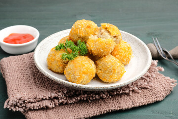 Delicious homemade bitterballen made from flour, cheese, milk coated with bread crumb filled with mozzarella. Selective focus image.