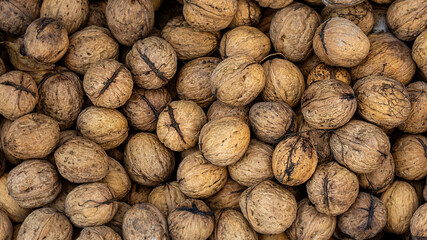 Walnuts with shells. Background of walnuts.