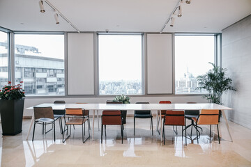 Modern style office lobby with bright Windows, wood floors, comfortable sofas and more.